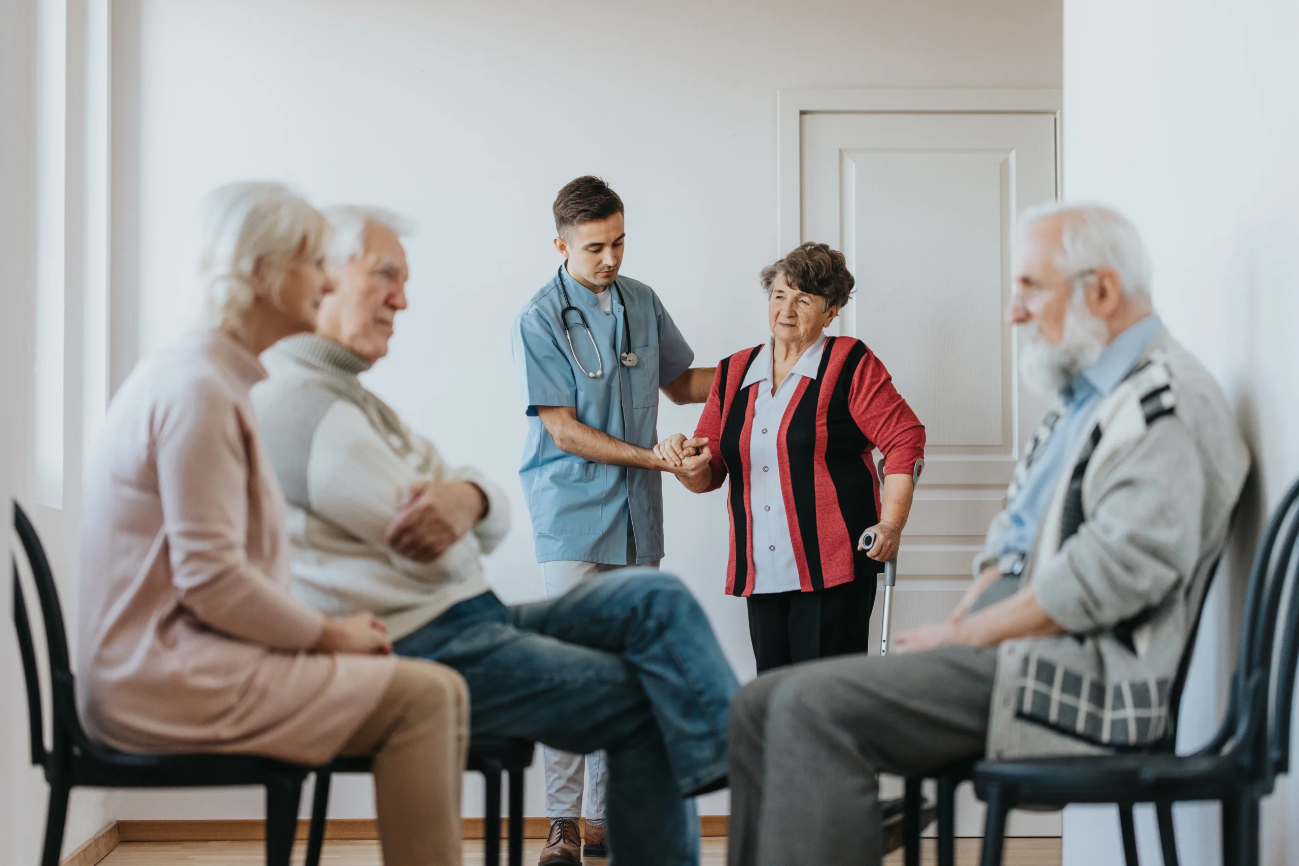 140547212_l Young doctor helping to an older patient walking out of the office